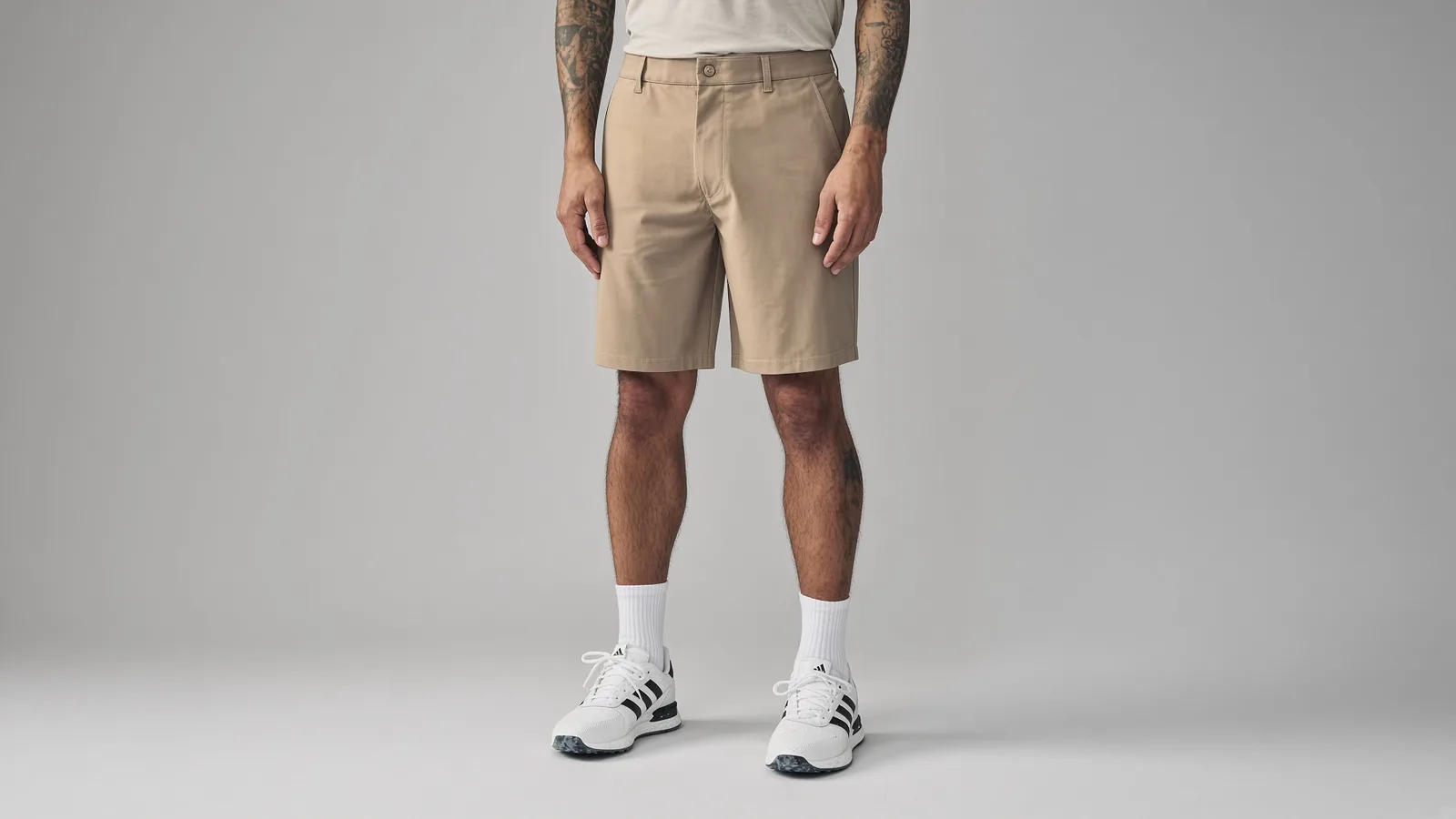 Beige flat-front golf shorts with side pockets worn with white crew socks and golf shoes