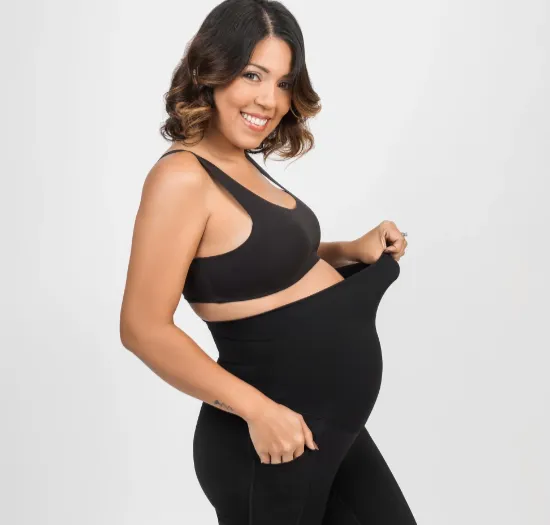 Custom maternity yoga apparel with adaptive crossover panel waistband designed for all trimesters and postpartum — inclusive yoga wear manufacturing