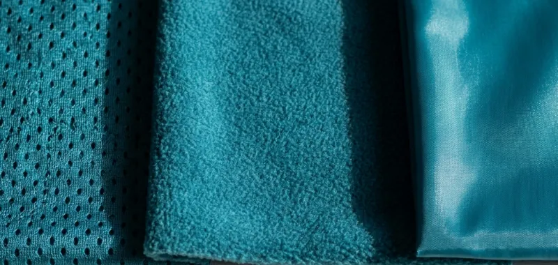 Same Pantone color shade variations on mesh, fleece, and nylon fabrics.