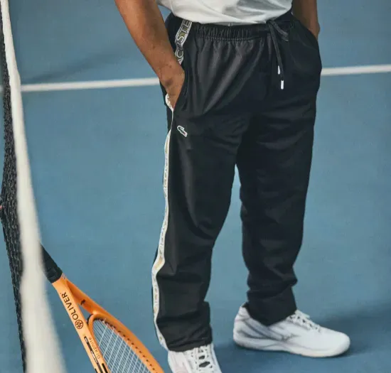 Custom tennis pants with tapered athletic fit and zip pockets