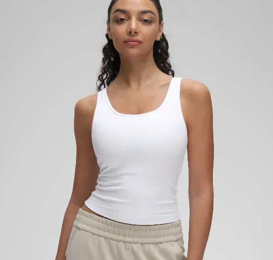 Custom yoga tank tops in cropped and relaxed silhouettes with built-in bra options — private label activewear manufacturing