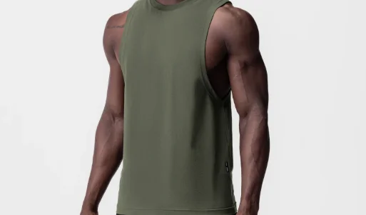 Athlete wearing an olive green sleeveless training tank top with a dropped armhole, plain studio background