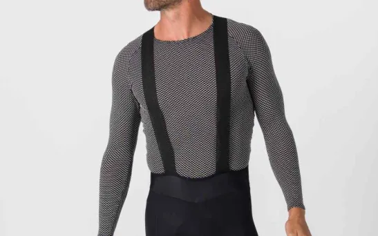 Close-up of a mesh long-sleeve cycling base layer with black bib straps worn under bib shorts