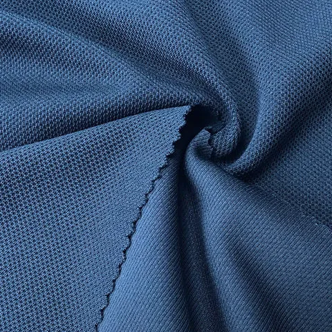 Moisture-wicking pique fabric close-up showing textured knit pattern