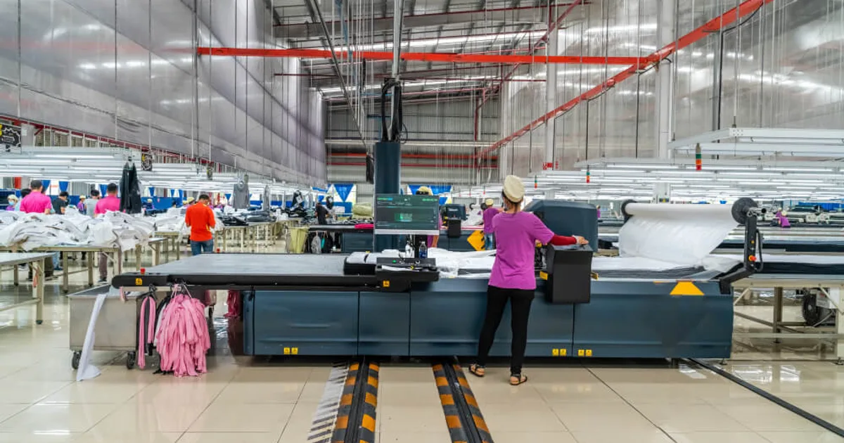 Sportswear manufacturing in the USA — automated fabric cutting on a factory floor