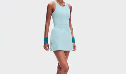 Light mint tennis dress with a racerback bodice and skirted hem, worn with teal sweatbands