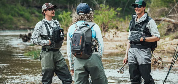 Angler wading in mountain river with fly fishing gear