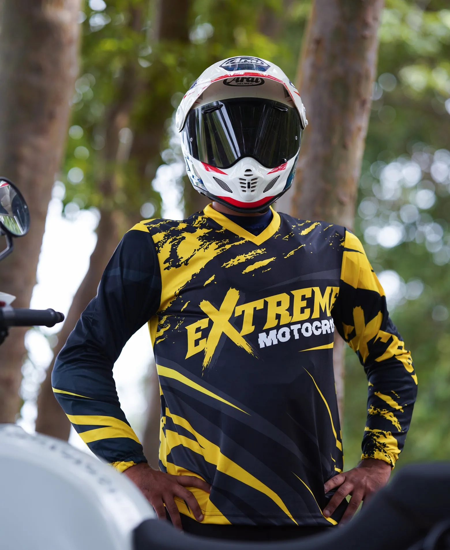 Motocross rider in attack position wearing custom sublimated race jersey