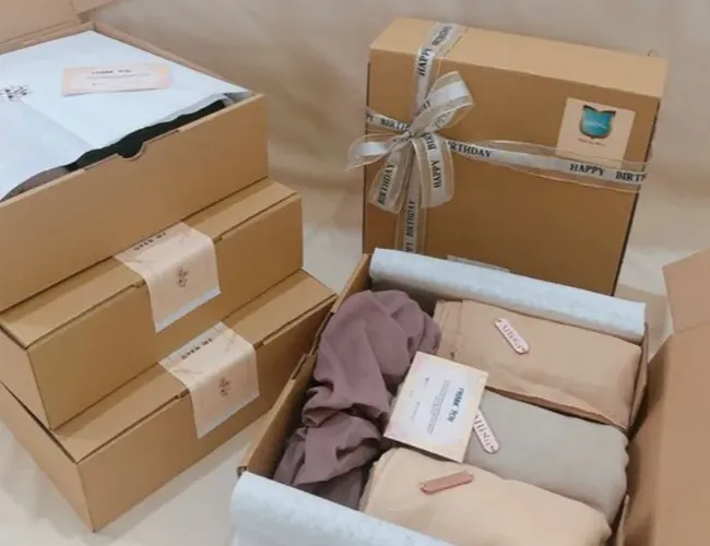 Complete custom clothing packaging solution with branded bags, tags, and boxes
