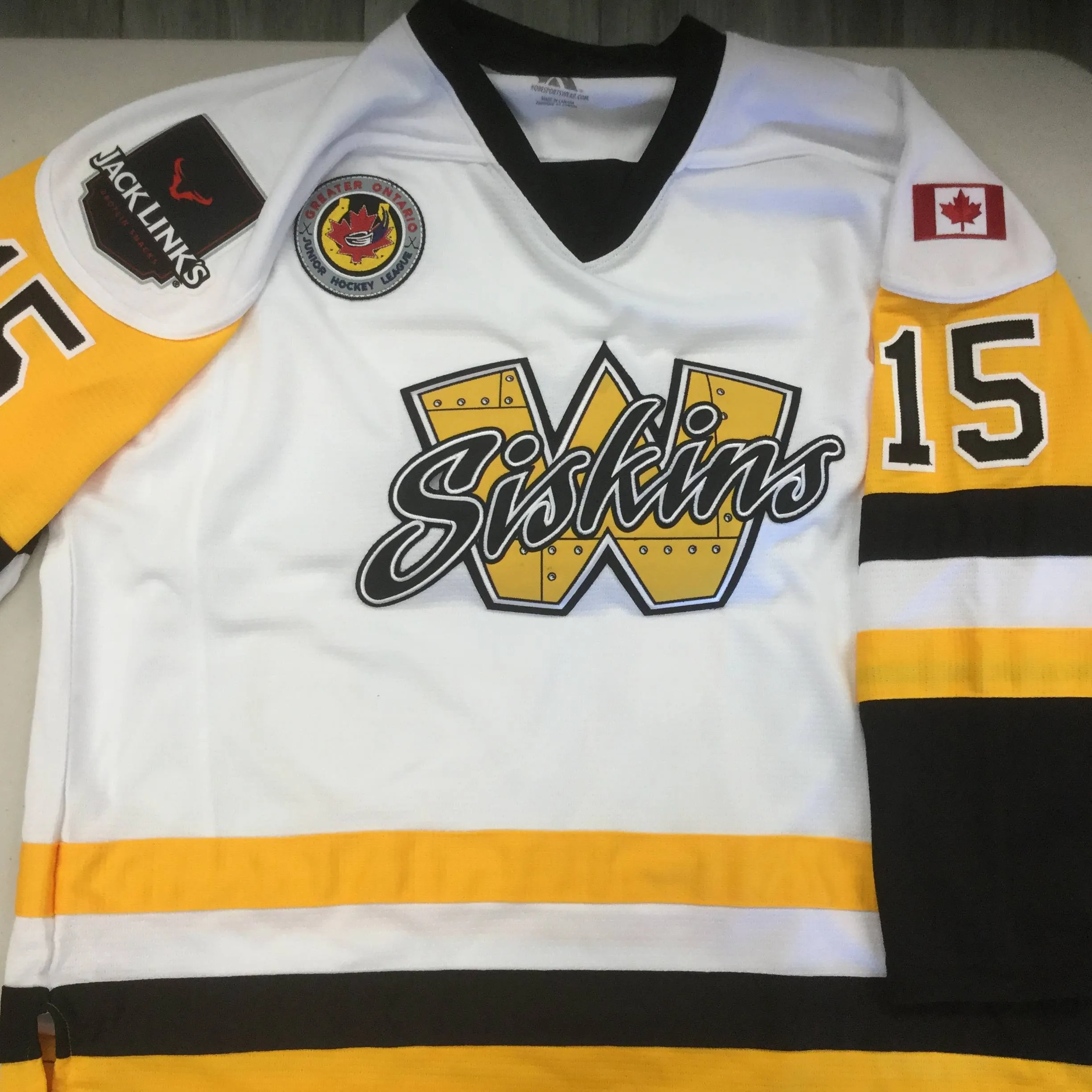 Custom hockey jersey with team logo and sponsor marks sublimated on front