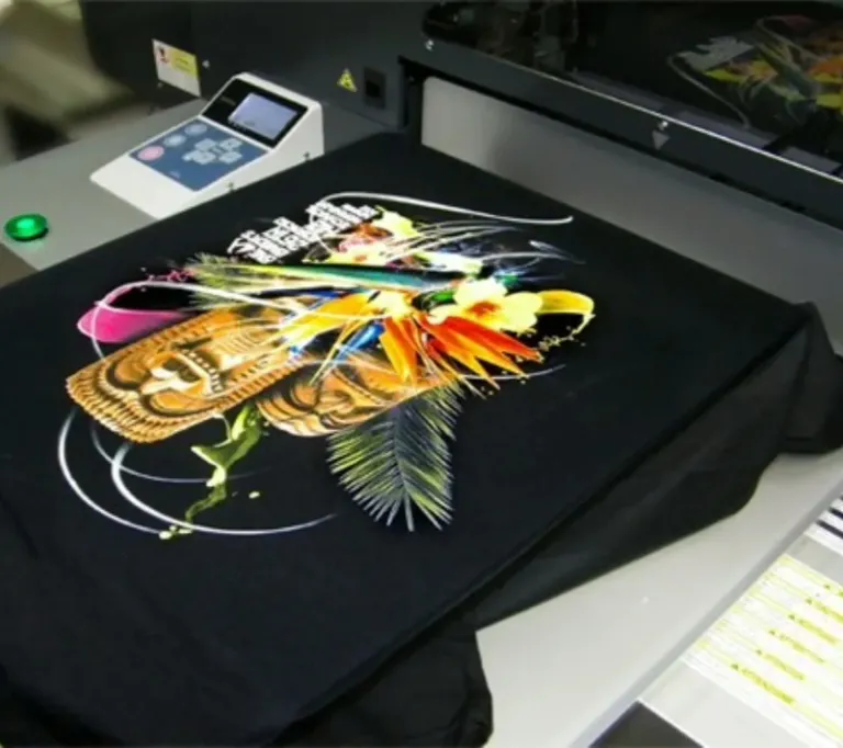 Direct to Garment (DTG) printing machine producing detailed multi-color apparel designs