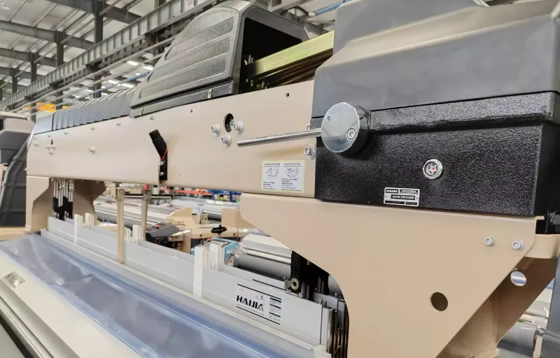 We walk the weaving floor in Shenzhen to inspect the air-jet looms producing cotton gauze.