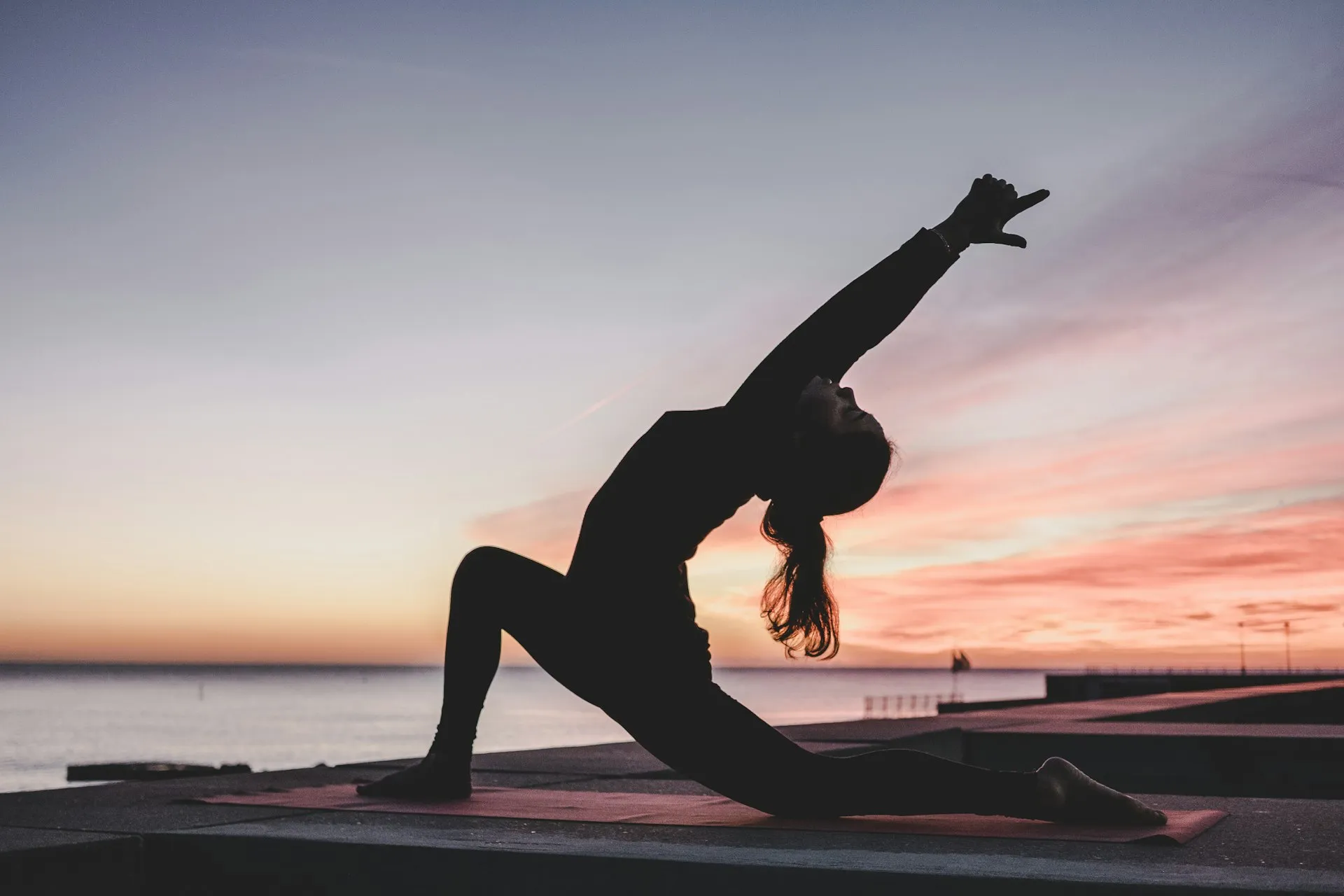 Yoga practitioner in coordinated set flowing through vinyasa